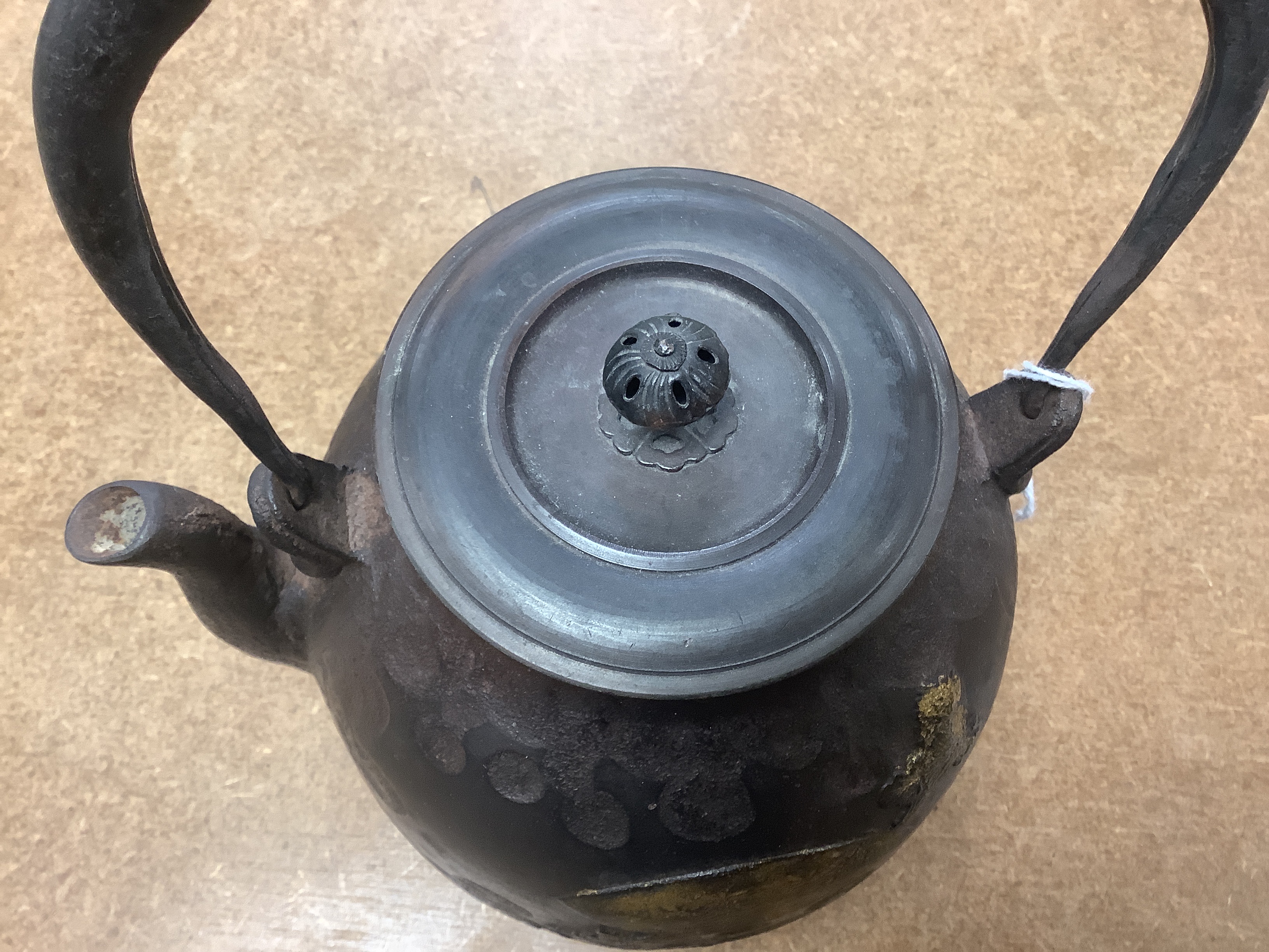 A Japanese iron tetsubin kettle with gilt decoration, a pair of Chinese cloisonné enamel vases, 12.5cm, a lacquered box with mother of pearl inlay, a carved black stone disc, 5cm diameter, a miniature ceramic pot and an